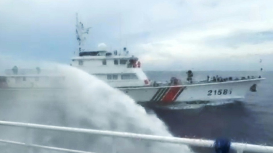  Philippines says ship hit by Chinese water cannon at disputed reef 