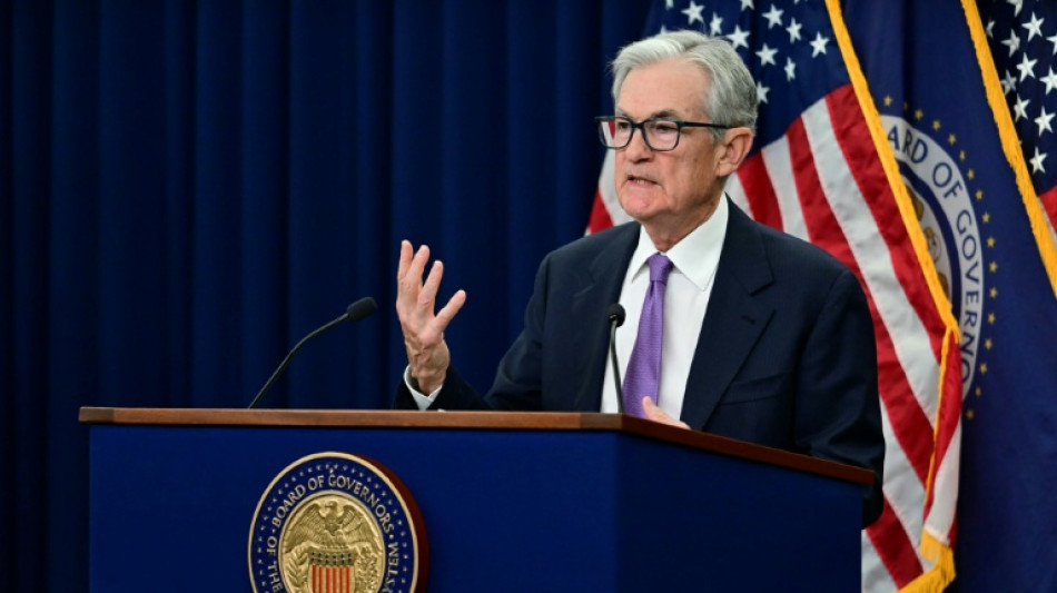 US stocks rise, dollar retreats as Fed tone less hawkish than feared