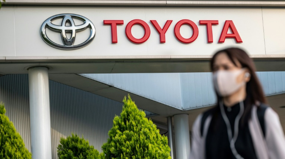 Toyota posts record full-year net profit, forecasts cautious