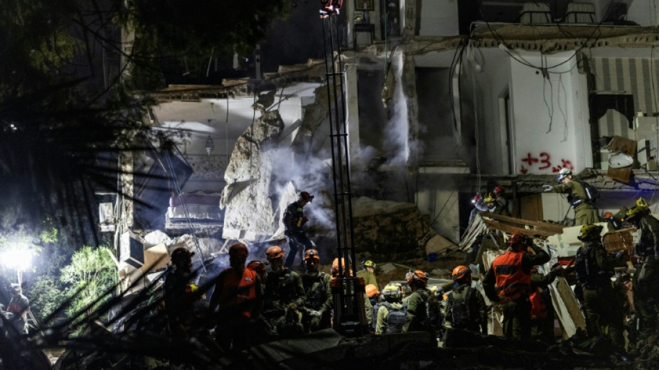  Israeli rescuers search for missing in building strike, two dead 