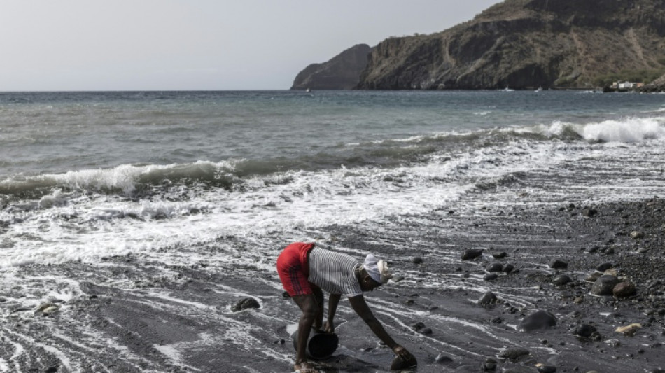  Women sand miners toil stripped Cape Verde beach 