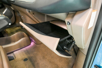 Pictured is the 'Parabolic Motion Glove Box,' a new concept glove box for electric vehicles developed by Hyundai Mobis, featured in the EV9. The parabolic motion mechanism is facilitated by the connecting component on the glove box's right side.